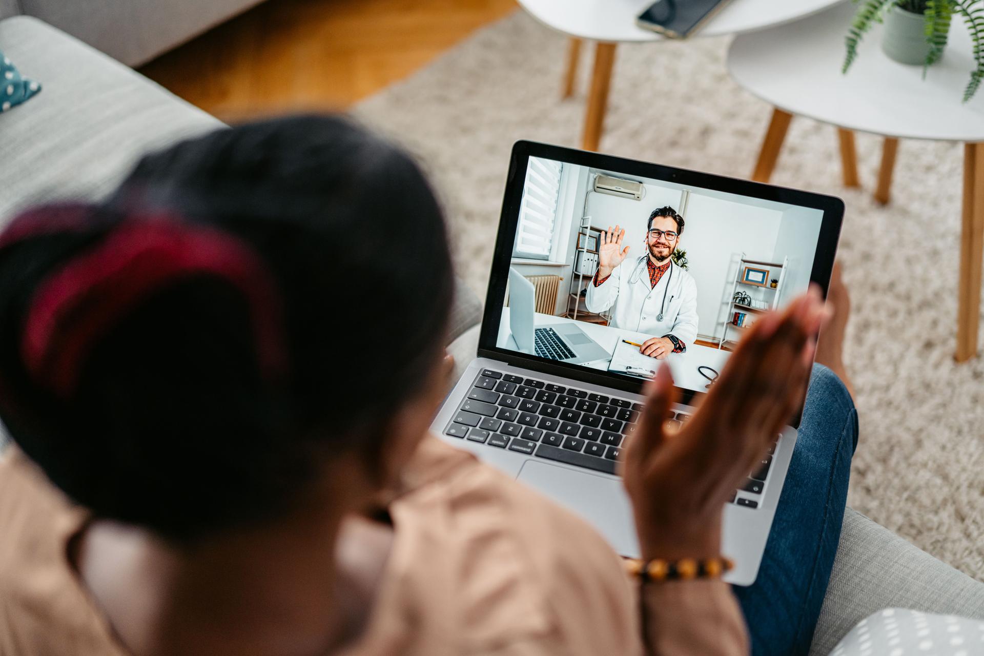 Young Woman Having A Doctor's Appointment Online At Home