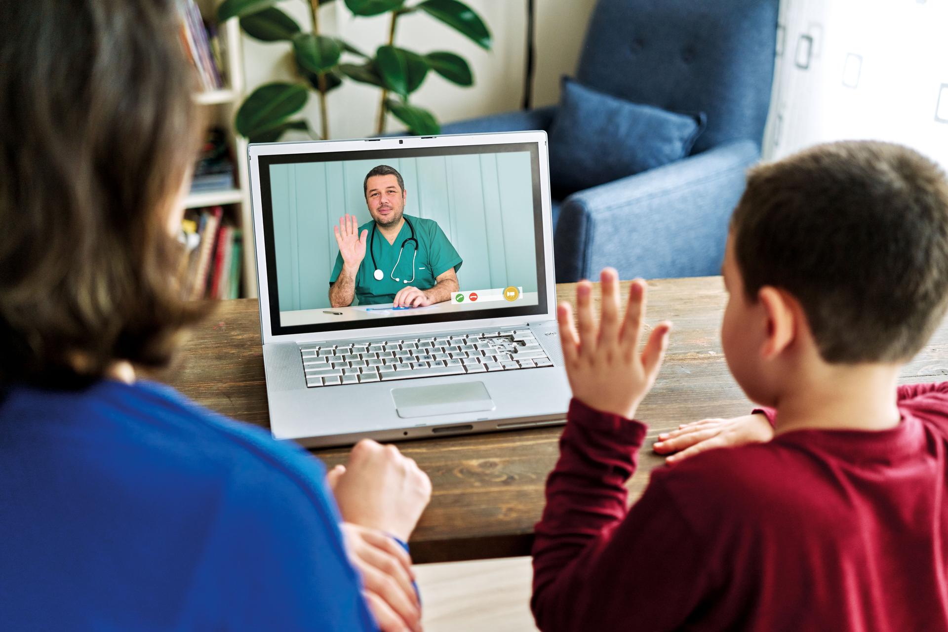 Mother and child talking with doctor on video call. There is good news from doctor. Family is happy.